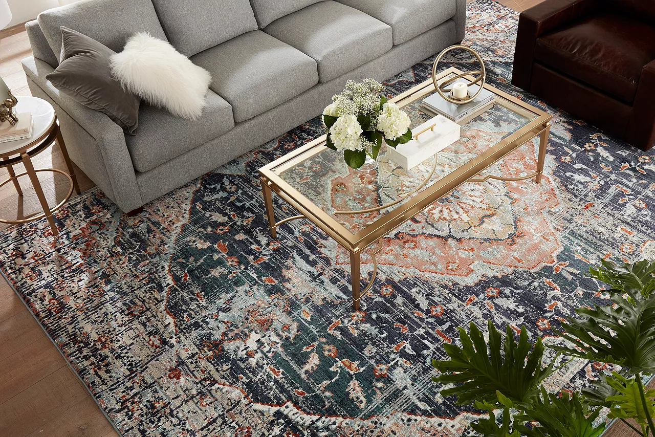 Image of living room with rug, sofa, coffee table and chair